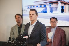 Man speaks at a podium