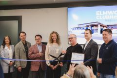 People lined up to cut celebratory ribbon