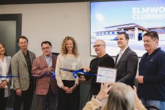 People lined up to cut celebratory ribbon