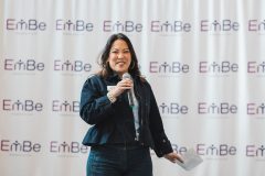 Woman speaks into microphone