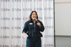 Woman speaking into microphone