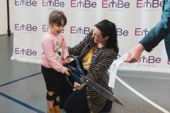 Woman and child holding ceremonial scissors