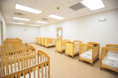 cribs lined up in small room