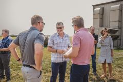 VP Gustaf, center, visits with Heartland Energy Chief Financial Officer Mike Malone, left, and Crabtree