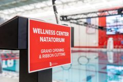 Closeup of podium with sign that reads Wellness Center Natatorium.