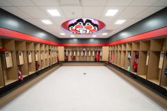 Interior of modern locker room with USD logo on the ceiling.