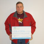 White Mayor Terry Wright accepted an energy efficiency grant from Heartland at the city's February council meeting.