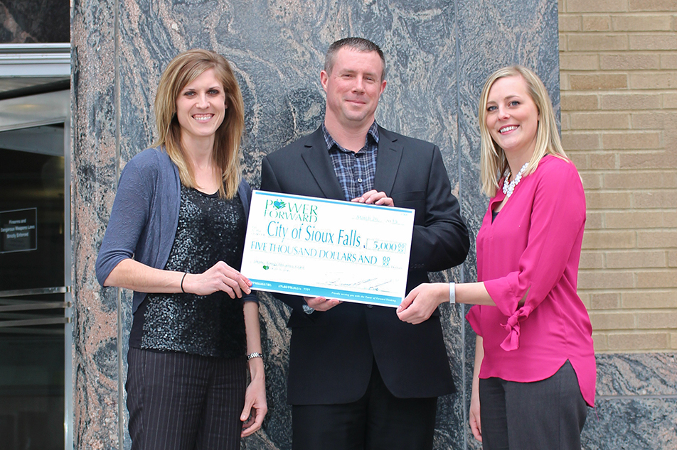 Heartland Communications Manager Ann Hyland presents an energy efficiency grant to Sioux Falls Light & Power Superintendent Jerry Jongeling and Sustainability Coordinator Jessica Lantgen.