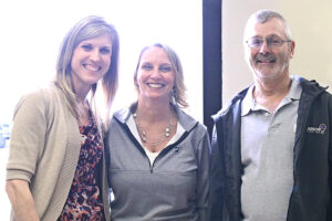 From left to right: Heartland Communications Manager Ann Hyland and Lake Area Improvement Corporation Executive Director Julie Gross celebrate with Dennis Poppen at his retirement open house.