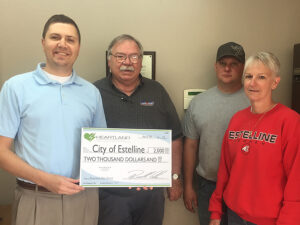 From left to right: Heartland Director of Economic Development Ryan Brown presents a grant to Estelline Rodeo Club members DanDeWitt, Lance Mennenga and Donna Thompson.