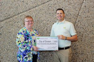 Brown, right, presents an economic development grant to Groton Finance Officer Anita Lowary.