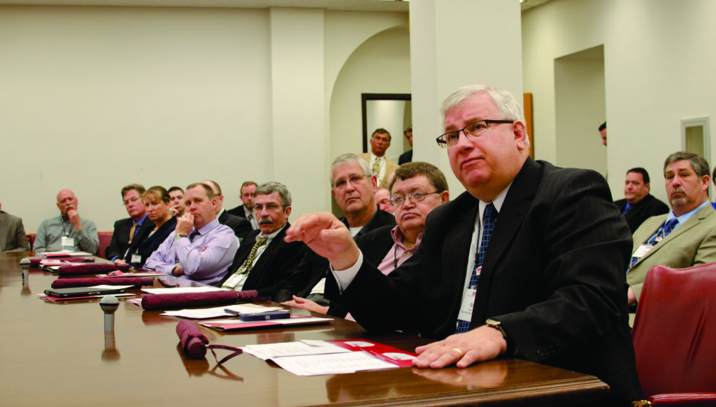 Brad Roos, foreground, discussed concerns in regards to third-party electric sales during visits with legislative leaders at the Minnesota State Capitol during the MMUA Legislative Conference. Photo courtesy Steve Downer, MMUA.