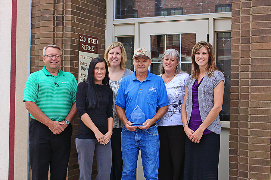 Gary Horton, center, accepts the Distinguished Service Award from Heartland officials and Akron city staff. From left to right: Heartland Customer Relations Manager Steve Moses, Akron TITLE TITLE NAME NAME, Clerk Melea Nielsen, Deputy Clerk Karen Wardrip and Heartland Communications Manager Ann Hyland.