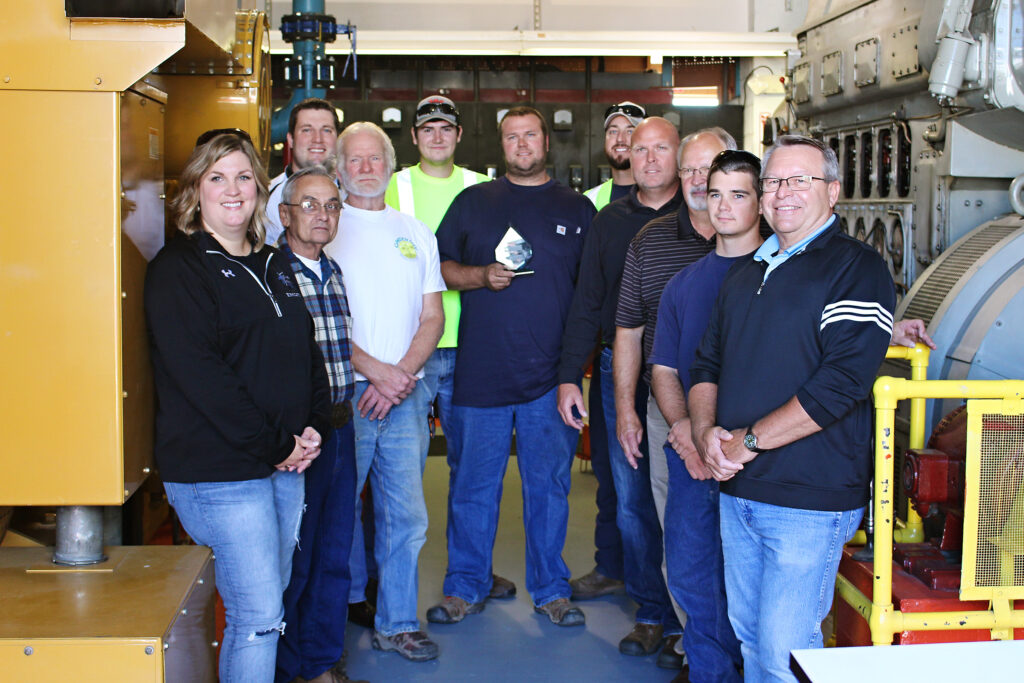 Mathias Phelps, center, accepts the Distinguished Service Award from colleagues, friends and family. From left to right: Mathias' wife Jessica Phelps, Lake Crystal PUC Chair Ron Williams, Lake Crystal PUC Vice Chair Brad Nelson, Lake Crystal City Administrator Taylor Gronau, 