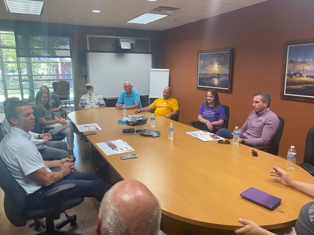 group of people sitting around a board room table