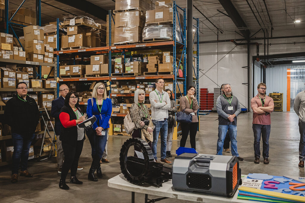 group of employees standing in a warehouse 