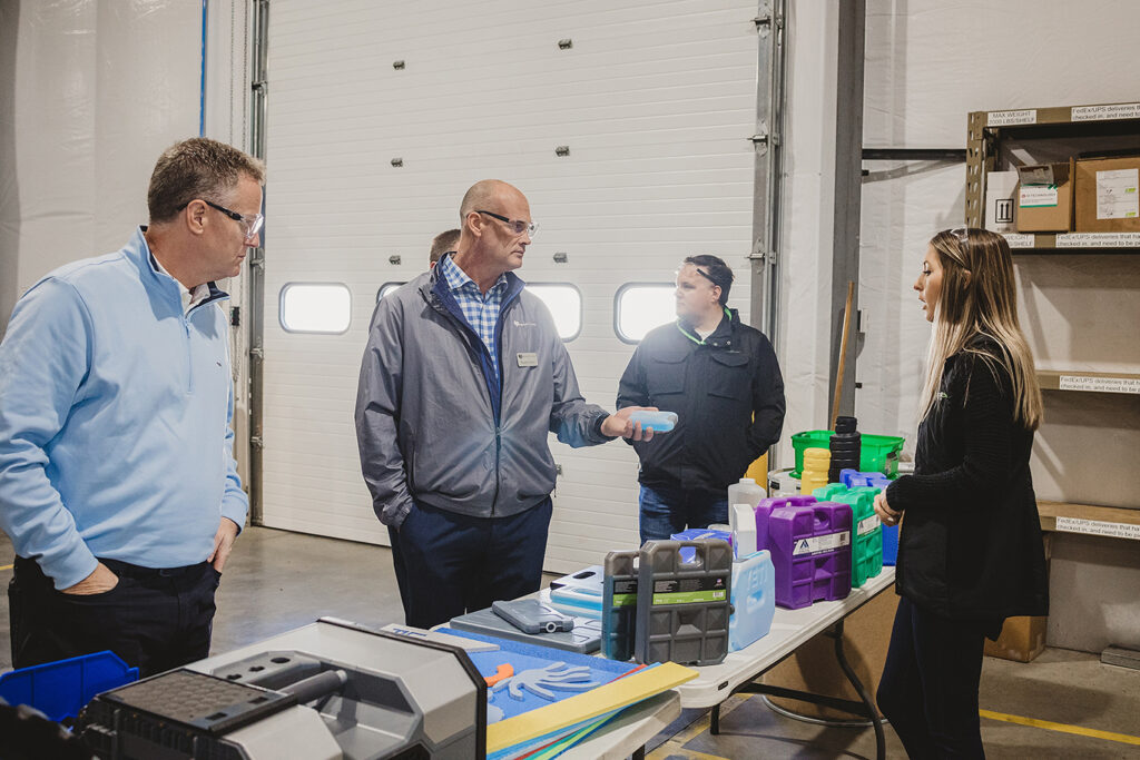 group of people talking in a manufacturing facility