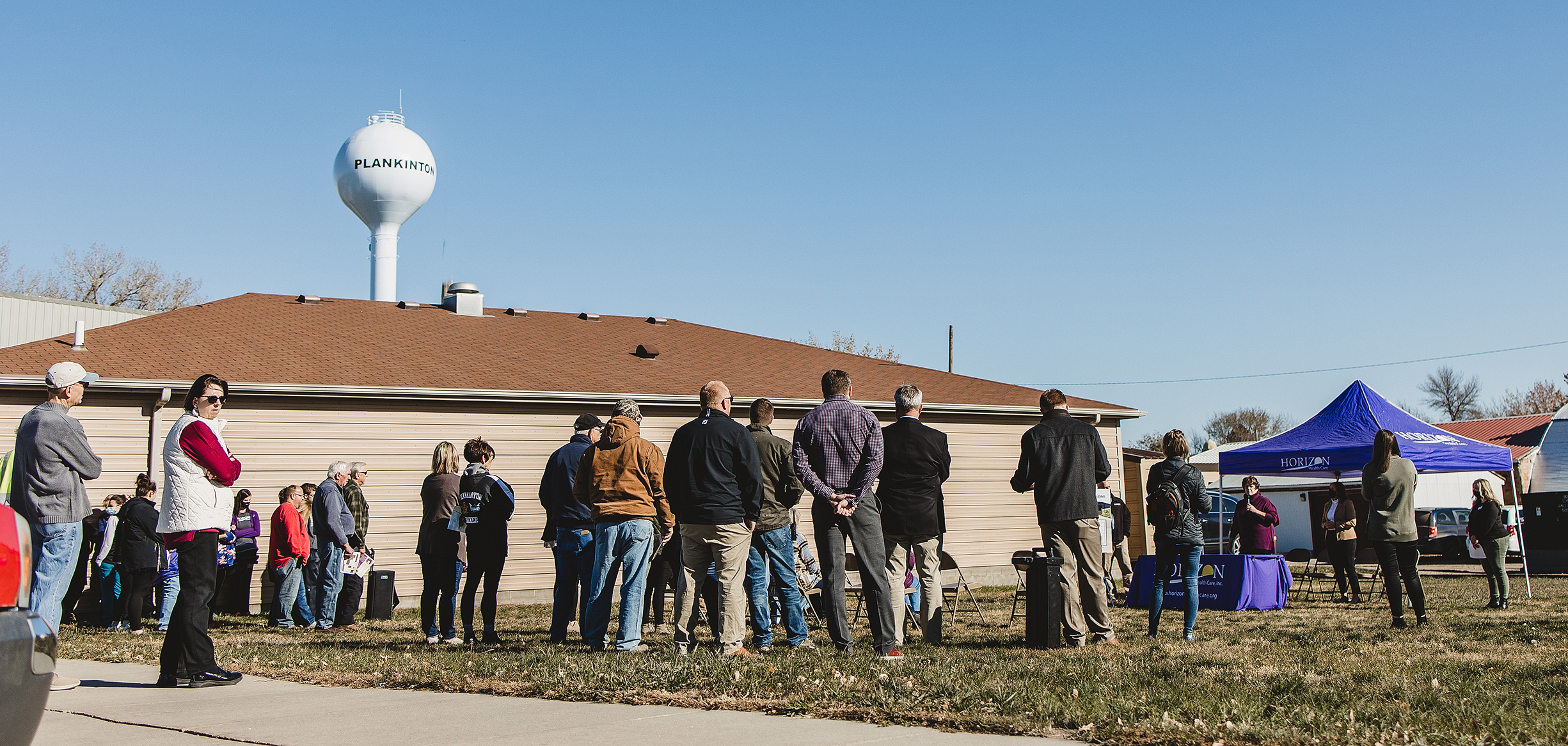 group of people gathered outside for a groundbreaking