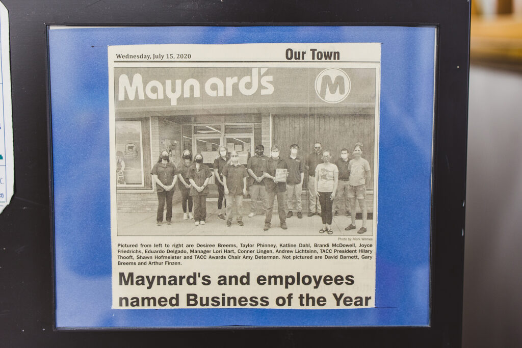 Newspaper cutout of an article for maynard's and employees earning 2020 Business of the Year