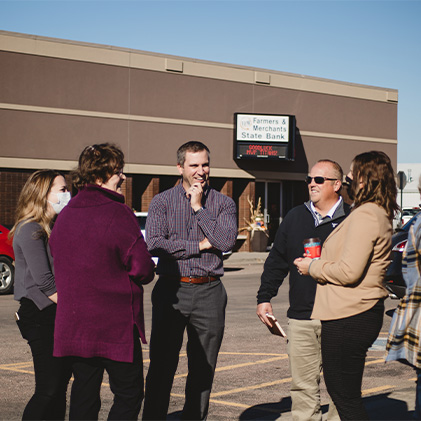 people standing around and talking in front of a building