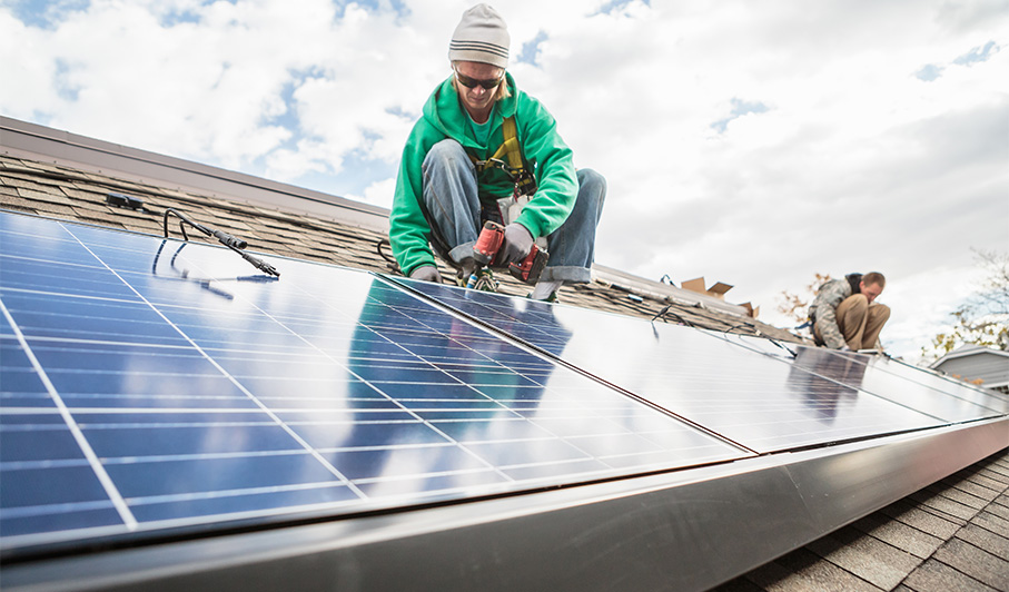 man working on solar panels