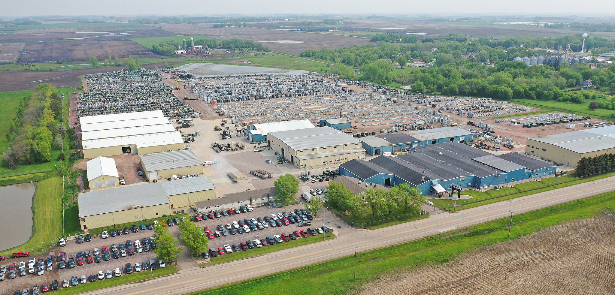 Aerial shot of manufacturing facilities, cars, transformers