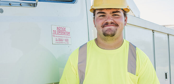 young man in hard hat and utility shirt