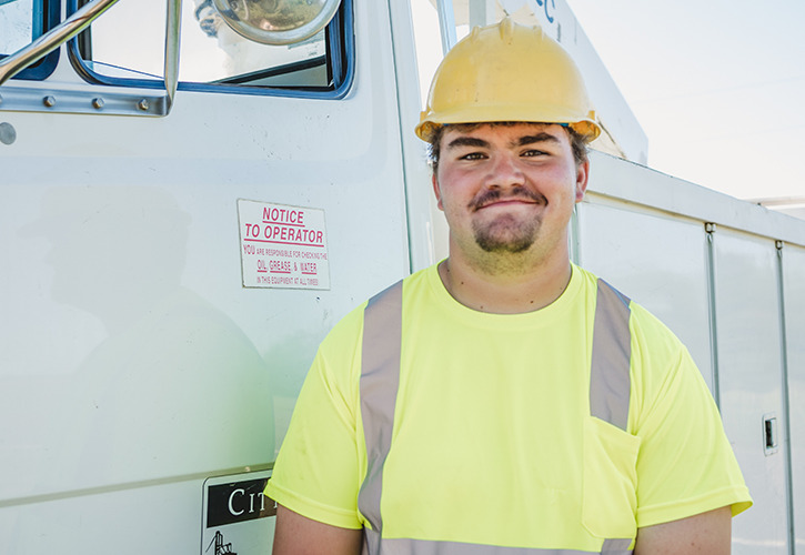 young man in hard hat and utility shirt