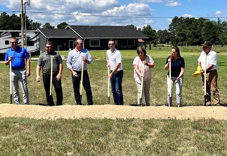 people stand with shovels for groundbreaking