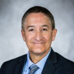 head and shoulders picture of man in suit and tie